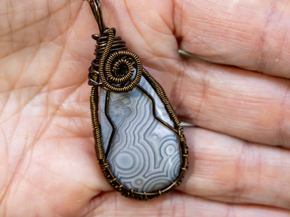 Wire-Wrapped Agate with Gray and White Patterns and Bronze Necklace